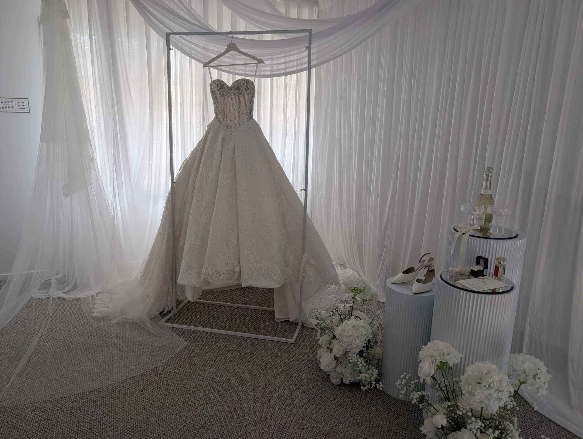 Wedding dress framed by drapes and florals